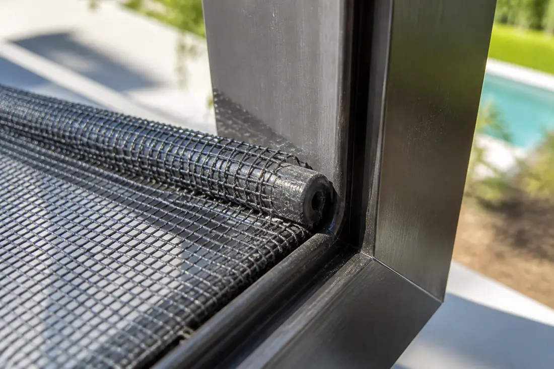 Screen mesh held in a frame groove by a rubber spline